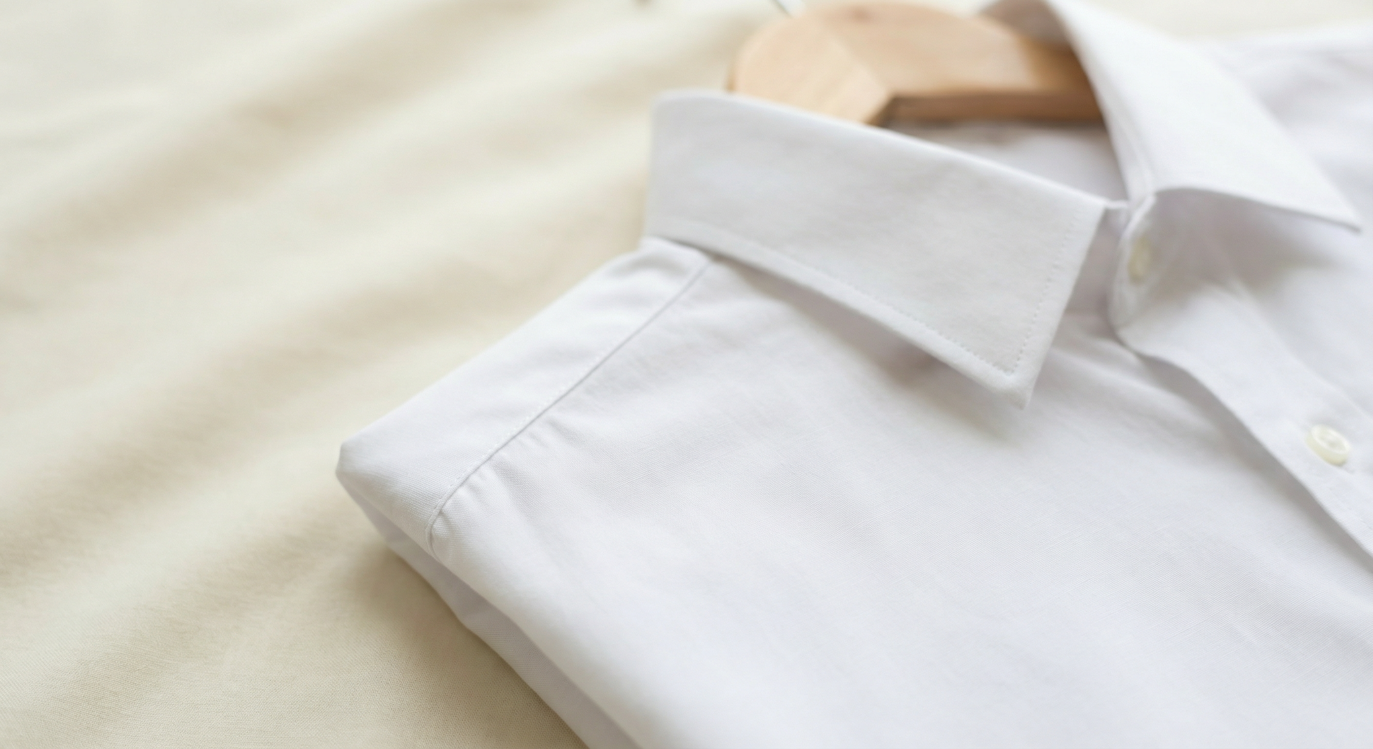 Close-up of a white shirt collar, clean and minimal